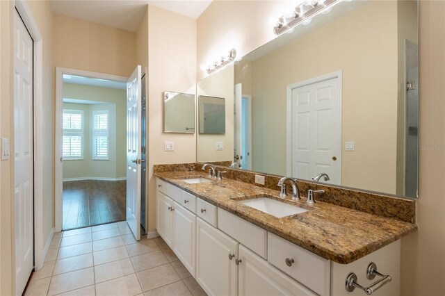 21209 Diamonte Dr, Land O Lakes, FL 34637 - full bath featuring double vanity, tile patterned floors, and baseboards