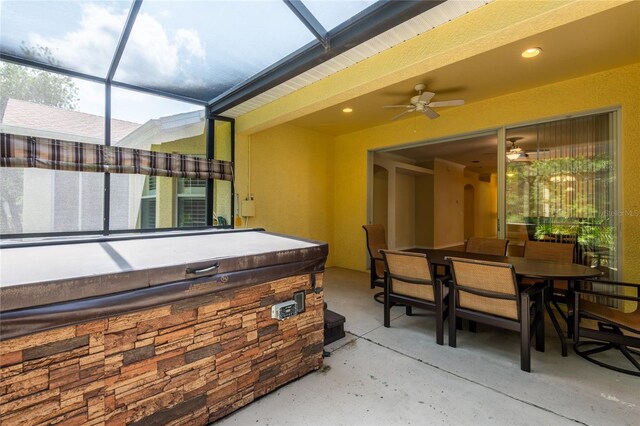 21209 Diamonte Dr, Land O Lakes, FL 34637 - view of patio featuring ceiling fan, outdoor dining area, a hot tub, and glass enclosure