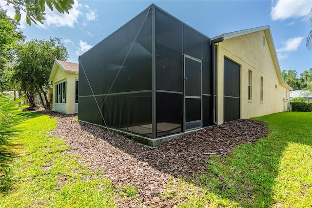 21209 Diamonte Dr, Land O Lakes, FL 34637 - view of home's exterior with stucco siding, a lawn, and glass enclosure