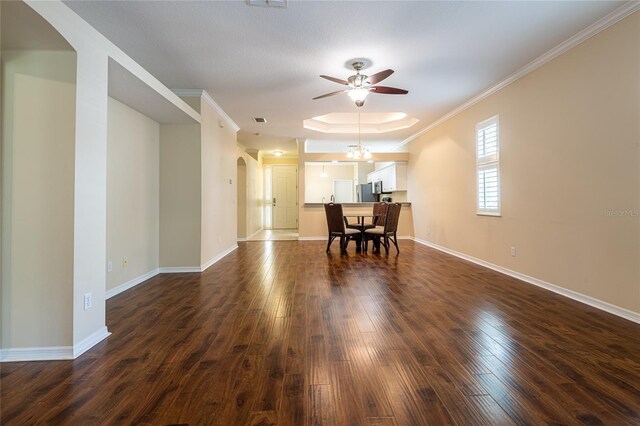 21209 Diamonte Dr, Land O Lakes, FL 34637 - dining area featuring arched walkways, ceiling fan, dark wood-style floors, crown molding, and baseboards