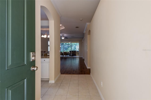 21209 Diamonte Dr, Land O Lakes, FL 34637 - hall with arched walkways, light tile patterned floors, and baseboards