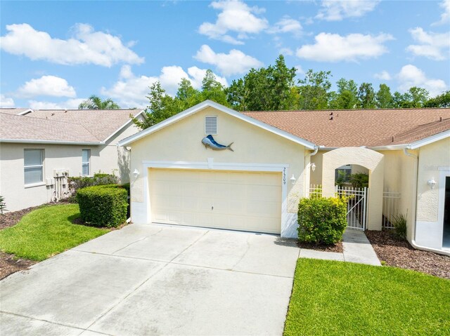 21209 Diamonte Dr, Land O Lakes, FL 34637 - single story home with concrete driveway, stucco siding, an attached garage, and a front lawn