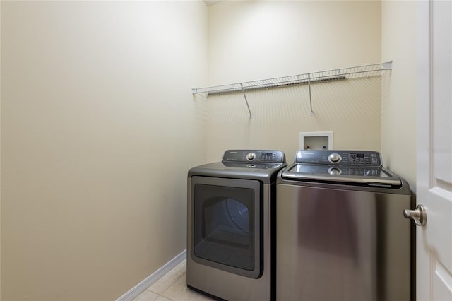 21209 Diamonte Dr, Land O Lakes, FL 34637 - laundry area featuring washer and clothes dryer, light tile patterned floors, and baseboards