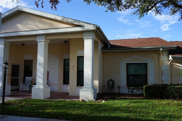 311 Kelsey Way Unit 3, Sun City Center, FL 33573 - view of front of house featuring covered porch, stucco siding, a front yard, and a shingled roof