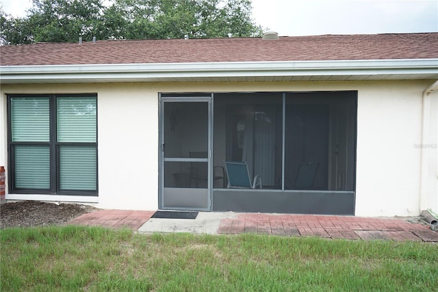 311 Kelsey Way Unit 3, Sun City Center, FL 33573 - back of property with a sunroom, stucco siding, and roof with shingles