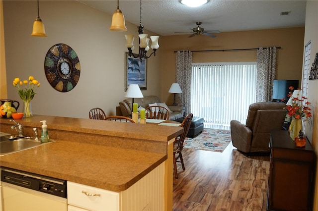 311 Kelsey Way Unit 3, Sun City Center, FL 33573 - kitchen with open floor plan, dishwasher, wood finished floors, a ceiling fan, and a chandelier