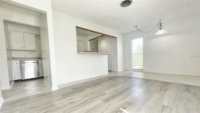 501 E Bay Dr Unit 3504, Largo, FL 33770 - unfurnished living room with light wood-style flooring and baseboards