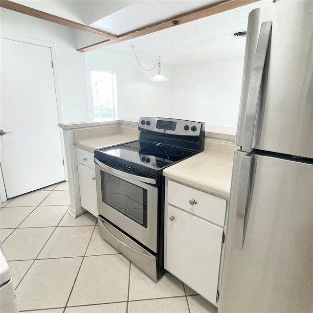 501 E Bay Dr Unit 3504, Largo, FL 33770 - kitchen featuring stainless steel appliances, light countertops, white cabinetry, and light tile patterned floors