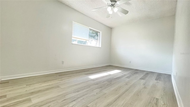 501 E Bay Dr Unit 3504, Largo, FL 33770 - empty room with a textured ceiling, light wood-style floors, ceiling fan, and baseboards