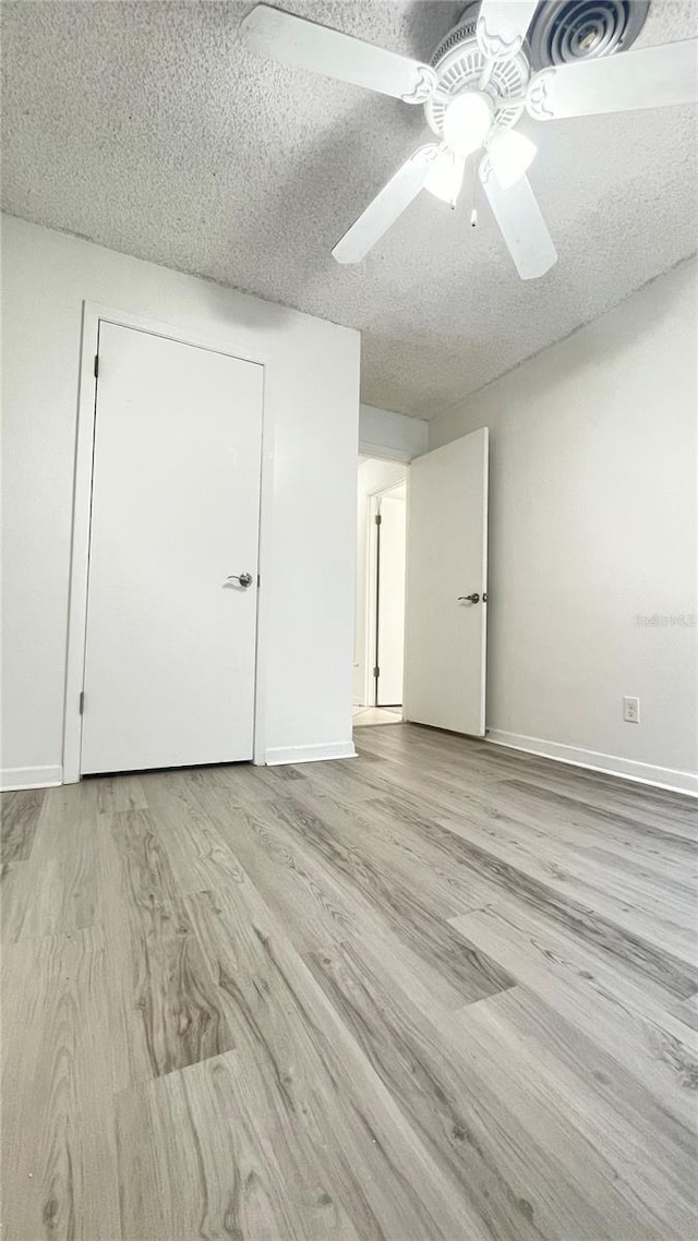 501 E Bay Dr Unit 3504, Largo, FL 33770 - unfurnished room featuring wood finished floors, a textured ceiling, ceiling fan, and baseboards