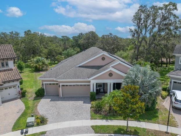 14223 Lambert Bridge Ln, Lithia, FL 33547 - view of front of property featuring decorative driveway and a garage