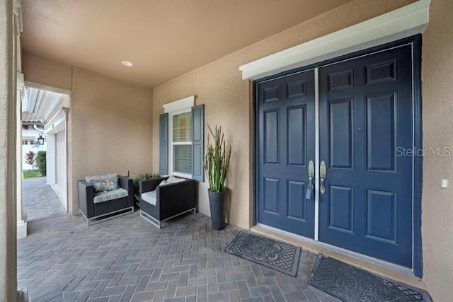 14223 Lambert Bridge Ln, Lithia, FL 33547 - doorway to property featuring stucco siding