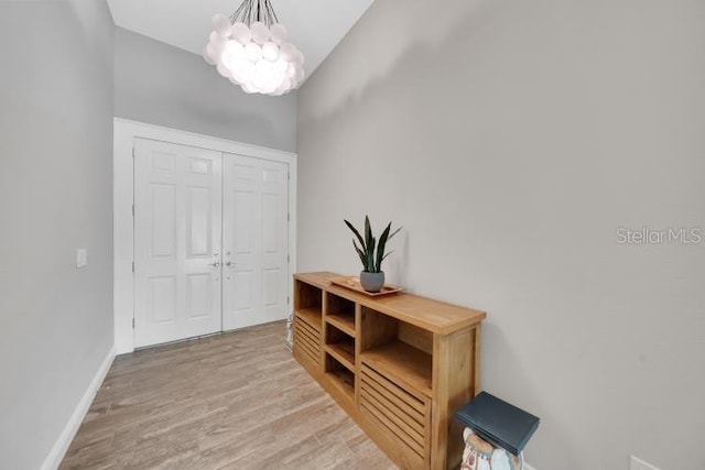 14223 Lambert Bridge Ln, Lithia, FL 33547 - foyer entrance with a chandelier, wood finished floors, and baseboards