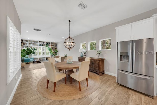 14223 Lambert Bridge Ln, Lithia, FL 33547 - dining area with light wood-type flooring, healthy amount of natural light, baseboards, a chandelier, and recessed lighting