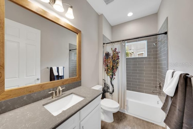 14223 Lambert Bridge Ln, Lithia, FL 33547 - full bath with vanity, wood finished floors, shower / tub combo with curtain, and toilet