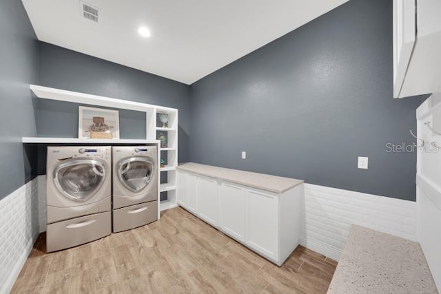 14223 Lambert Bridge Ln, Lithia, FL 33547 - laundry room with separate washer and dryer and light wood-style flooring