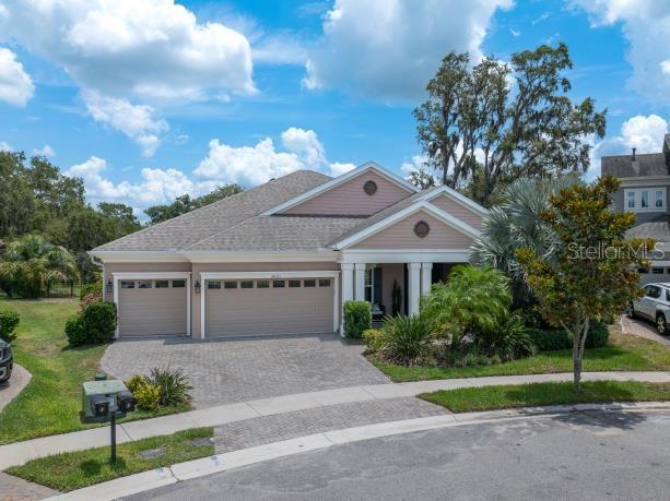 14223 Lambert Bridge Ln, Lithia, FL 33547 - view of front of home with a garage, decorative driveway, a front yard, and roof with shingles