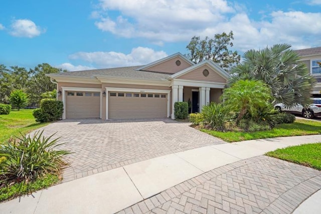 14223 Lambert Bridge Ln, Lithia, FL 33547 - view of front of house with decorative driveway and a garage