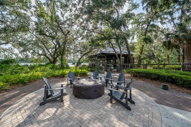 14223 Lambert Bridge Ln, Lithia, FL 33547 - view of patio / terrace with an outdoor fire pit