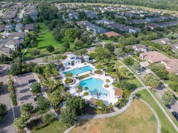 14223 Lambert Bridge Ln, Lithia, FL 33547 - aerial overview of property's location with a pool and nearby suburban area