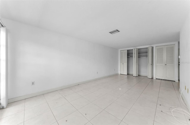 2700 Bayshore Blvd Unit 2110, Dunedin, FL 34698 - unfurnished bedroom featuring multiple closets and baseboards