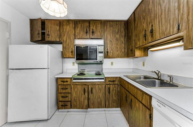 2700 Bayshore Blvd Unit 2110, Dunedin, FL 34698 - kitchen with white appliances, a sink, light countertops, and light tile patterned floors