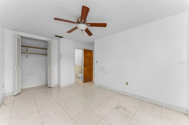 2700 Bayshore Blvd Unit 2110, Dunedin, FL 34698 - unfurnished bedroom featuring a closet, ceiling fan, and baseboards
