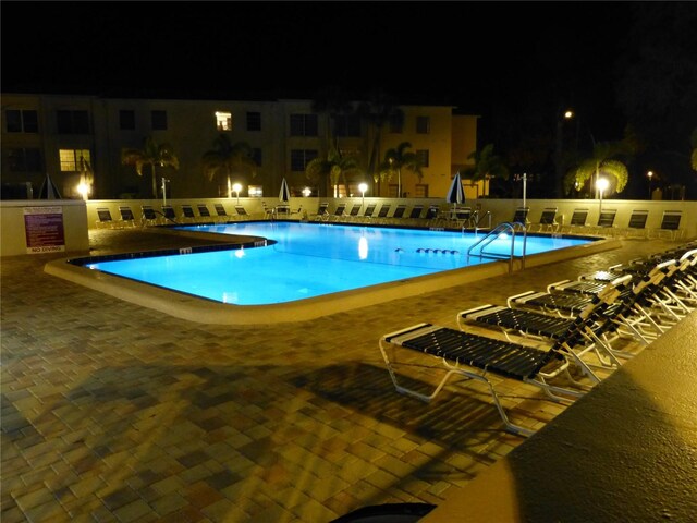 2700 Bayshore Blvd Unit 2110, Dunedin, FL 34698 - pool at twilight with a community pool and a patio area