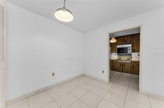 2700 Bayshore Blvd Unit 2110, Dunedin, FL 34698 - unfurnished dining area featuring baseboards and light tile patterned floors