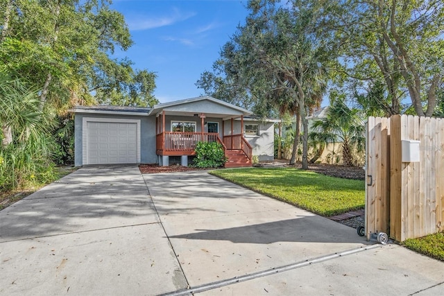 1045 28th Ave S, Saint Petersburg, FL 33705 - view of front of home featuring a porch, an attached garage, concrete driveway, and stucco siding