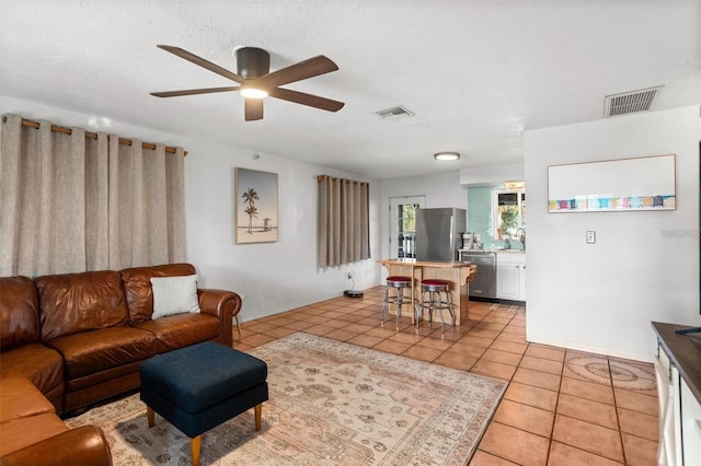 1045 28th Ave S, Saint Petersburg, FL 33705 - living room featuring light tile patterned flooring, baseboards, and a ceiling fan