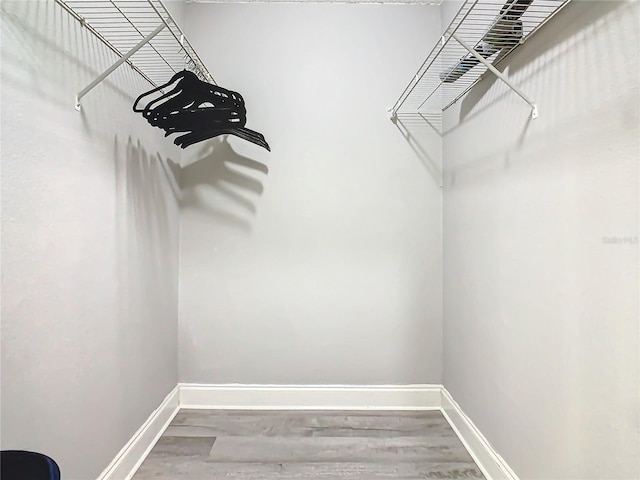 spacious closet with wood finished floors
