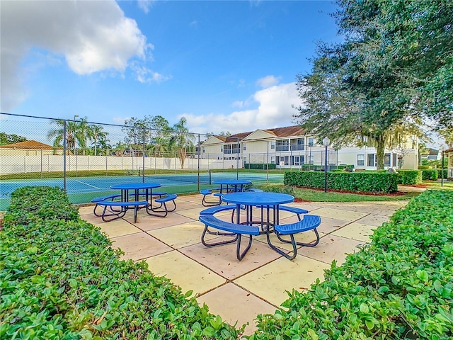view of property's community with a tennis court