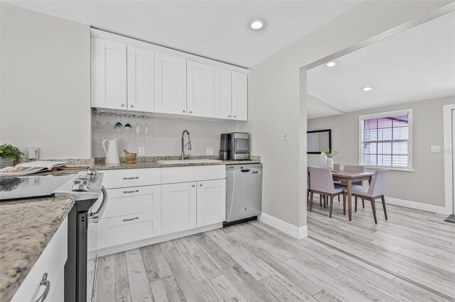 812 60th St S, Gulfport, FL 33707 - kitchen featuring appliances with stainless steel finishes, a sink, light wood-style flooring, recessed lighting, and white cabinets
