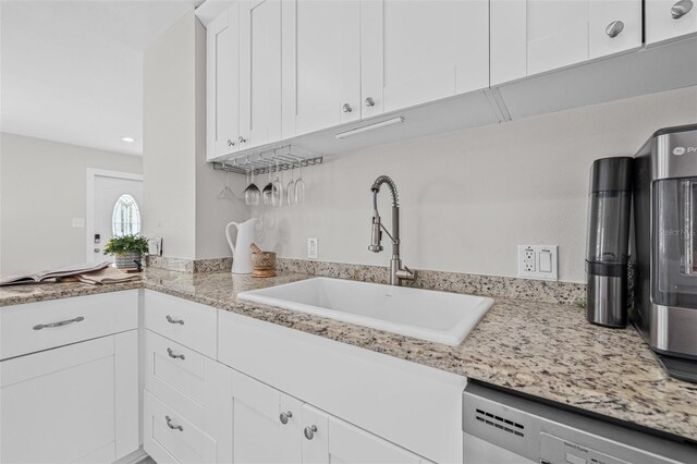 812 60th St S, Gulfport, FL 33707 - kitchen featuring a sink, dishwasher, white cabinets, light stone countertops, and recessed lighting