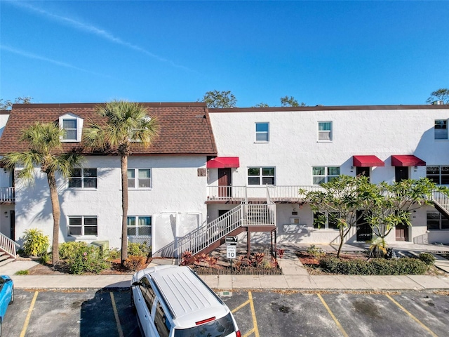 9201 Tudor Dr Unit C212, Tampa, FL 33615 - view of property featuring uncovered parking and stairway