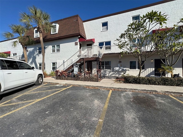 9201 Tudor Dr Unit C212, Tampa, FL 33615 - view of property with uncovered parking and stairs