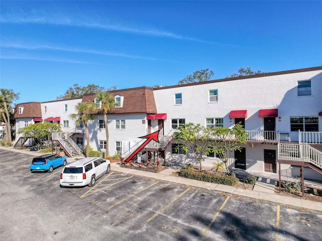 9201 Tudor Dr Unit C212, Tampa, FL 33615 - view of building exterior featuring stairs and uncovered parking