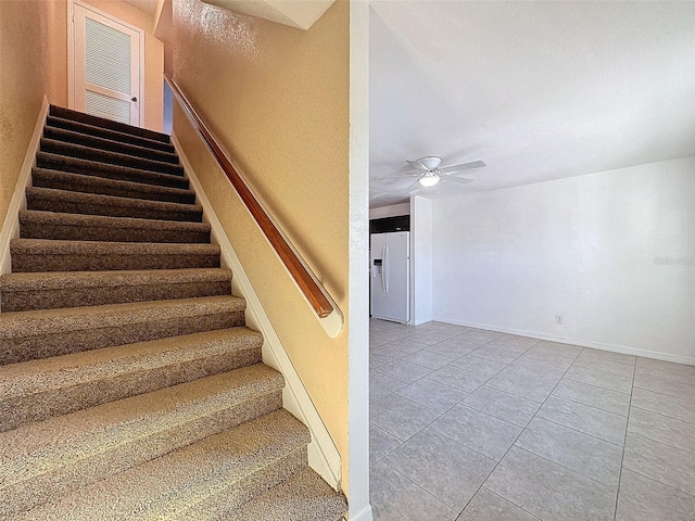 9201 Tudor Dr Unit C212, Tampa, FL 33615 - stairway featuring ceiling fan, tile patterned flooring, and baseboards