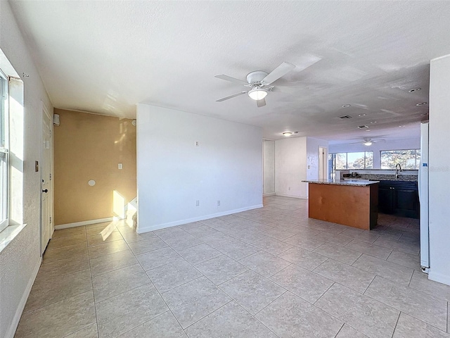 9201 Tudor Dr Unit C212, Tampa, FL 33615 - unfurnished living room featuring a ceiling fan, a sink, and light tile patterned flooring