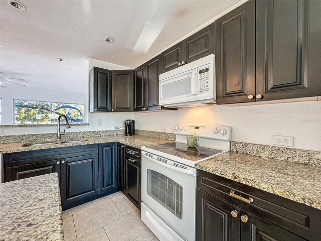 9201 Tudor Dr Unit C212, Tampa, FL 33615 - kitchen with white appliances, a sink, light tile patterned flooring, and ceiling fan