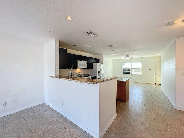 9201 Tudor Dr Unit C212, Tampa, FL 33615 - kitchen featuring stainless steel refrigerator with ice dispenser, white microwave, range with electric stovetop, a sink, and a ceiling fan