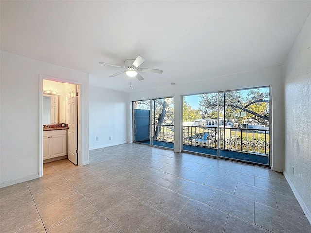 9201 Tudor Dr Unit C212, Tampa, FL 33615 - empty room featuring a ceiling fan, baseboards, and light tile patterned floors