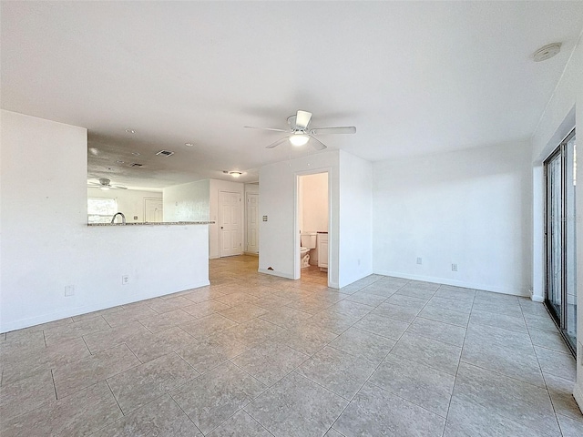 9201 Tudor Dr Unit C212, Tampa, FL 33615 - unfurnished living room with a ceiling fan and baseboards