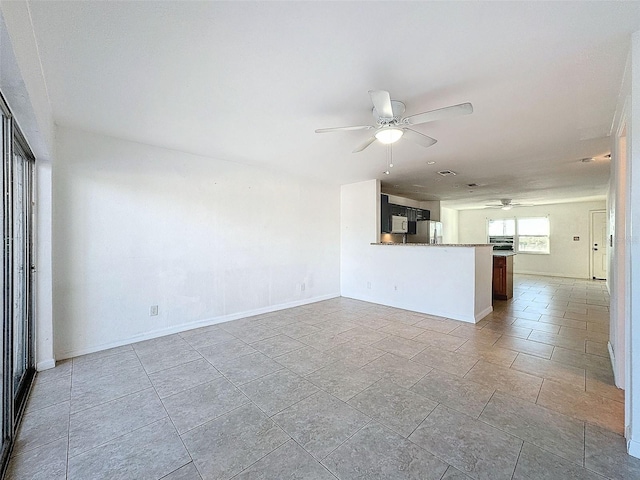9201 Tudor Dr Unit C212, Tampa, FL 33615 - unfurnished living room featuring ceiling fan and baseboards