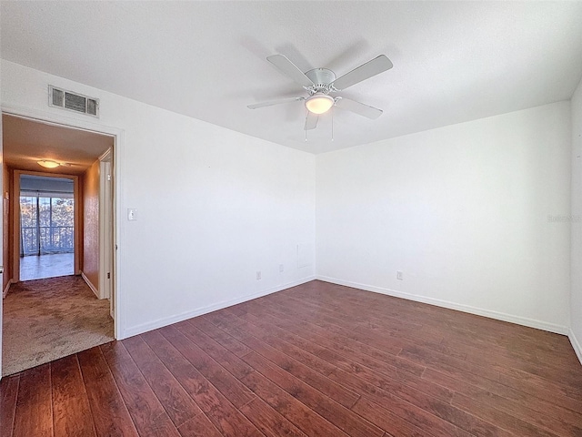 9201 Tudor Dr Unit C212, Tampa, FL 33615 - spare room with dark wood-style floors, ceiling fan, and baseboards
