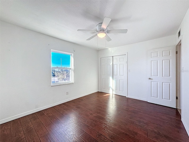 9201 Tudor Dr Unit C212, Tampa, FL 33615 - unfurnished bedroom featuring wood finished floors, a closet, baseboards, and ceiling fan