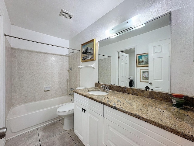 9201 Tudor Dr Unit C212, Tampa, FL 33615 - bathroom featuring tile patterned floors, vanity, washtub / shower combination, toilet, and a textured wall
