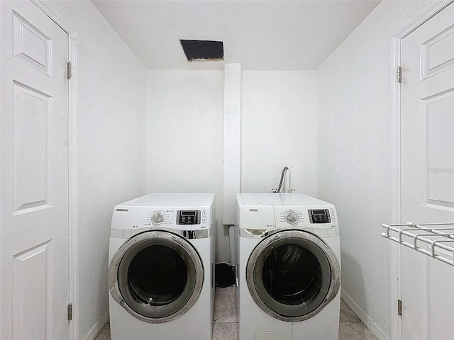 9201 Tudor Dr Unit C212, Tampa, FL 33615 - washroom with washer and dryer and baseboards