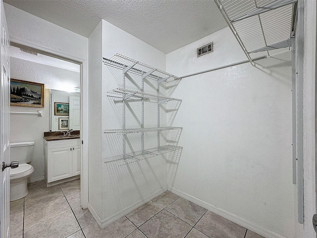 9201 Tudor Dr Unit C212, Tampa, FL 33615 - spacious closet featuring light tile patterned flooring
